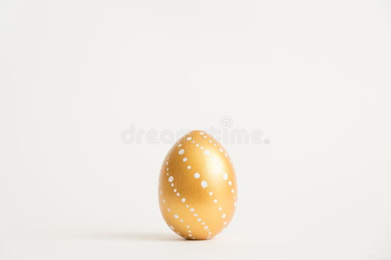 Easter golden decorated egg isolated on white background. Minimal easter concept. Top view, flatlay.