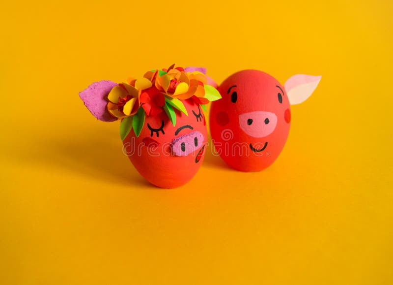 Easter holiday concept with cute handmade eggs: pink pig. Friends piglets