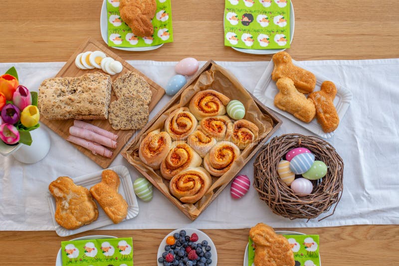 Easter holiday table. Easter cakes and colored eggs on a wooden table royalty free stock image