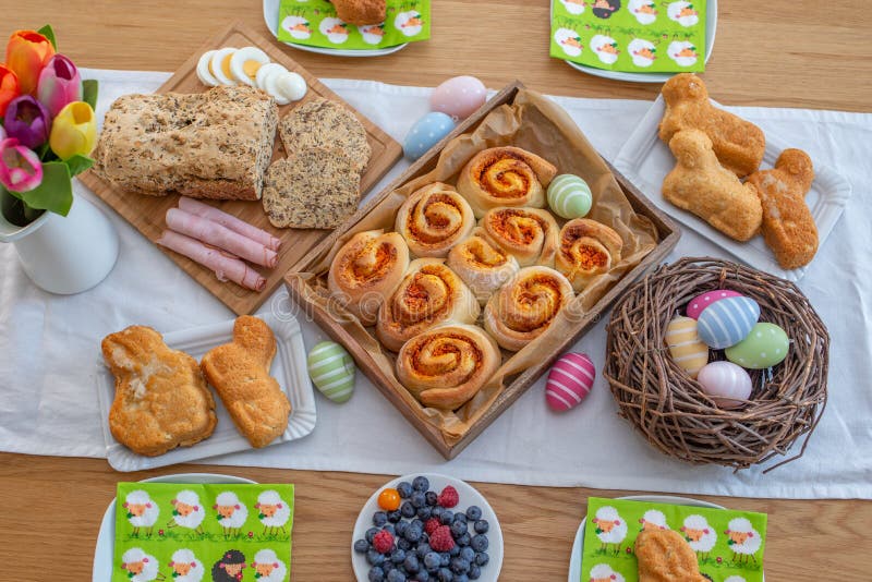 Easter holiday table. Easter cakes and colored eggs on a wooden table royalty free stock images