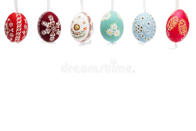 Hanging row of hand painted easter eggs on white background. Hanging row of hand painted easter eggs on white background