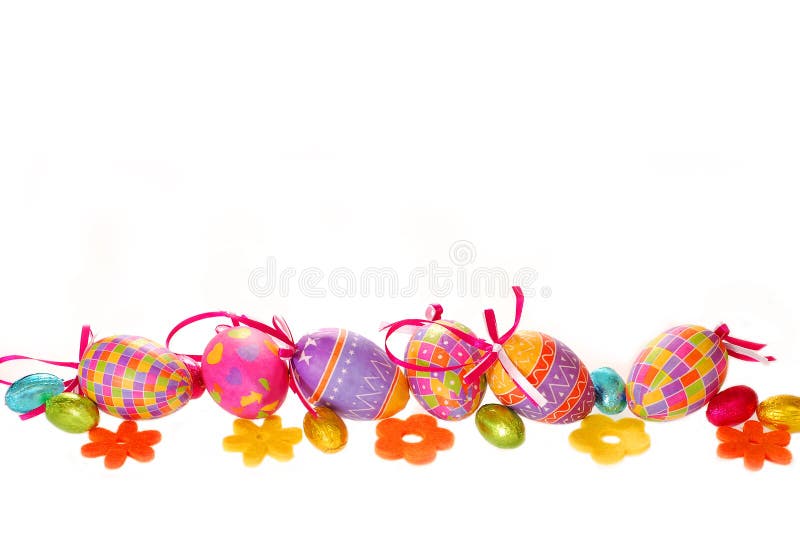 Border with a row of colorful eggs and felt flowers isolated on white. Border with a row of colorful eggs and felt flowers isolated on white