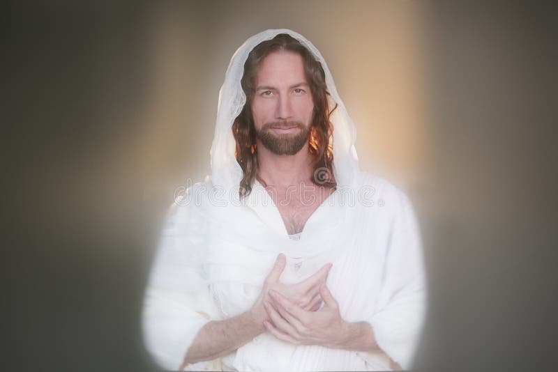 Easter Risen Prayer Handsers Bread. Jesus Christ Portrait image in white back lit with hands at heart offering a loving blessing and soft smile. Powerful eyes royalty free stock photo Easter Risen Prayer Handsers Bread. Jesus Christ Portrait image in white back lit with hands at heart offering a loving blessing and soft smile. Powerful eyes royalty free stock photo