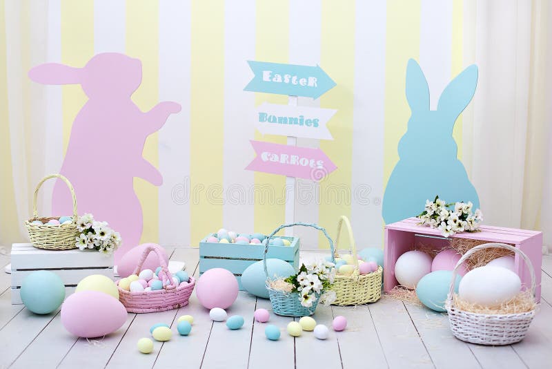 Happy easter! Many colorful Easter eggs with bunnies and baskets of flowers! Children`s playroom. Spring room decoration and easter decor. Location for the Easter photo shoot. Family home decoration. Happy easter! Many colorful Easter eggs with bunnies and baskets of flowers! Children`s playroom. Spring room decoration and easter decor. Location for the Easter photo shoot. Family home decoration.