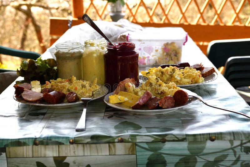 Easter table with salad, eggs, ham, sausage, beetroot and horseradish