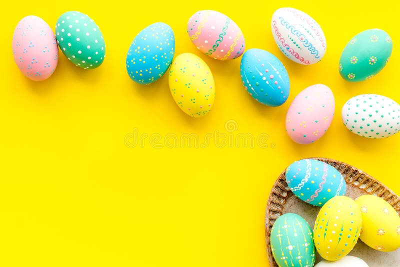 Easter Traditions. Colorful Easter Eggs in Basket on Yellow Background