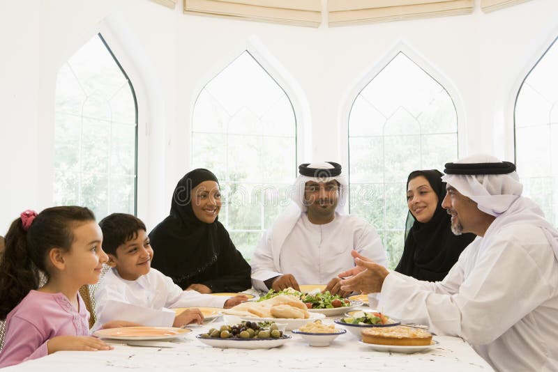 A Middle Eastern family enjoying a meal. A Middle Eastern family enjoying a meal.