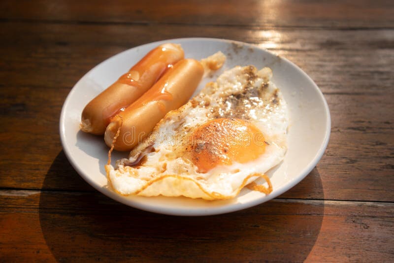 Easy Breakfast Set of Fried Egg and Sausages in a Dish Stock Photo