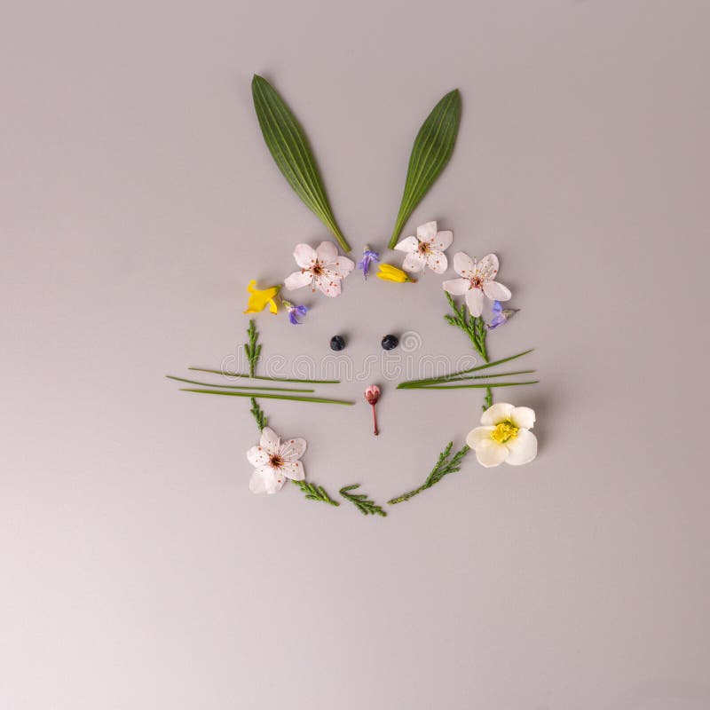 spring nature craft for kids, rabbit or bunny made of leaves and flowers, top view, activity for children