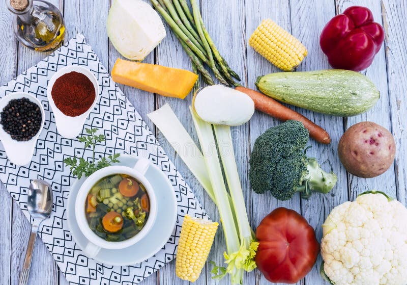 Eat healthy with fresh, ready-to-eat homemade vegetable soup. Raw vegetables on the wooden table, olive oil and croutons. Directly above view of healthy wand royalty free stock photography Eat healthy with fresh, ready-to-eat homemade vegetable soup. Raw vegetables on the wooden table, olive oil and croutons. Directly above view of healthy wand royalty free stock photography