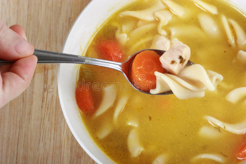 Eating Chicken Noodle Soup stock photo. Image of hand 5528730
