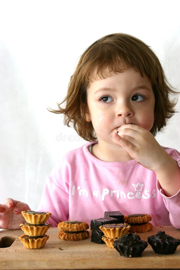 Eating chocolate cakes stock image. Image of cookies, sweet 2015989