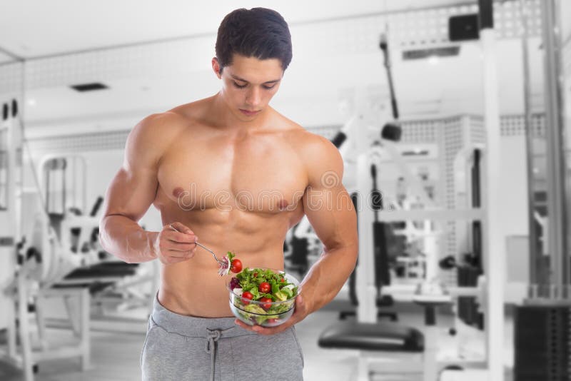 Eating food salad bodybuilding bodybuilder fitness gym body builder building muscles young man studio