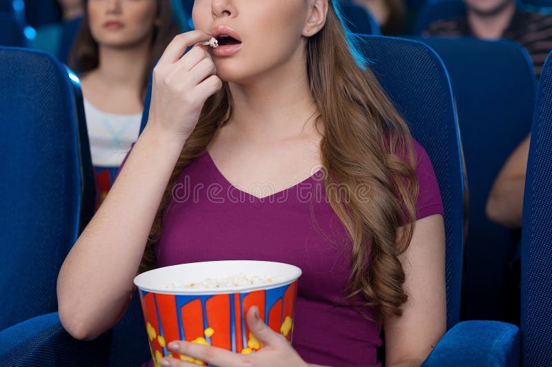 Man Eating Popcorn at the Cinema. Stock Photo Image of expression