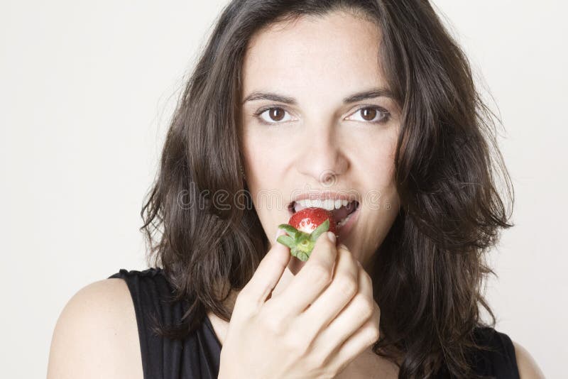 Eating red strawberry