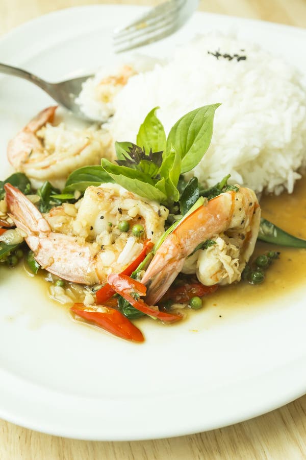 Eating Shrimp Fried in Holy Basil with Thai Jasmine Rice Stock Photo