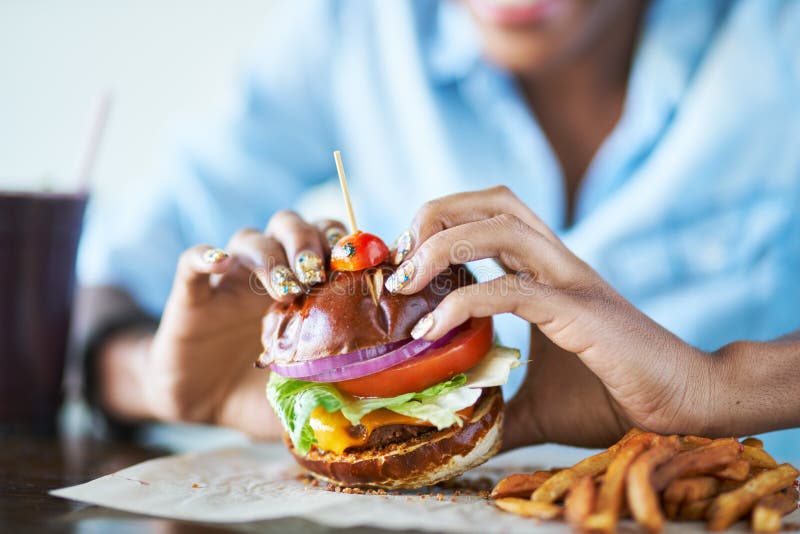 Eating vegan burger