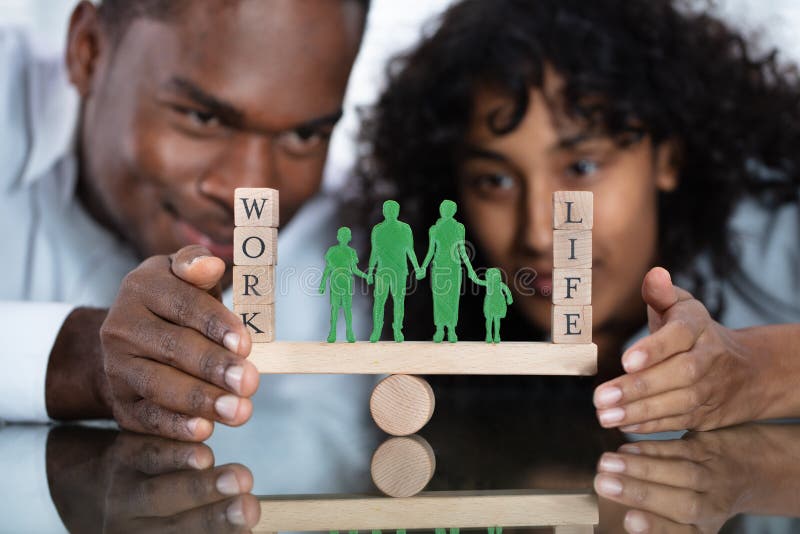 Young Couple Protecting Work And Life Balance On Seesaw. Young Couple Protecting Work And Life Balance On Seesaw