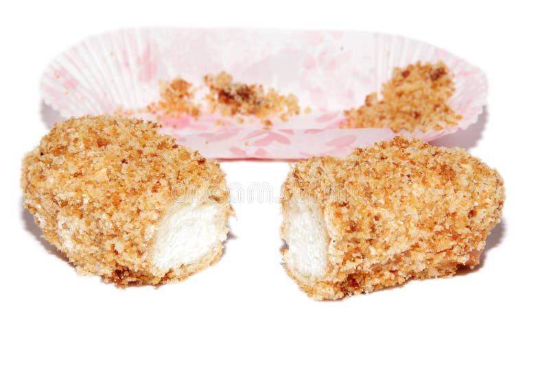 Eclair con una crema en un fondo blanco foto de archivo libre de regalías