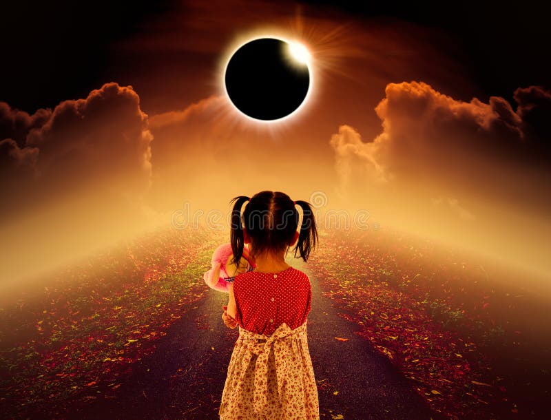 Amazing scientific natural phenomenon. Total solar eclipse glowing above child on pathway with night sky and clouds. Full solar eclipse is photo realistic illustration. Sepia tone. Amazing scientific natural phenomenon. Total solar eclipse glowing above child on pathway with night sky and clouds. Full solar eclipse is photo realistic illustration. Sepia tone.