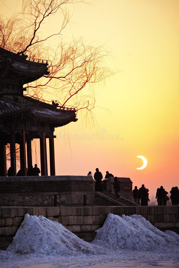 Eclipse of the sun in Beijing with a silhouette of the Summer Palace in the foreground. Eclipse of the sun in Beijing with a silhouette of the Summer Palace in the foreground.