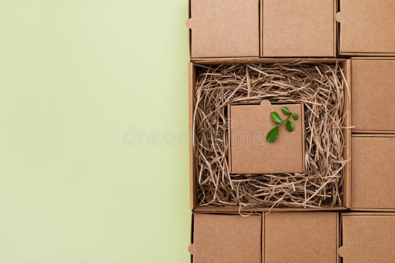 Eco concept with green leaf in cardboard box from craft paper. Plastic free, zero waste, sustainable lifestyle stock images Eco concept with green leaf in cardboard box from craft paper. Plastic free, zero waste, sustainable lifestyle stock images