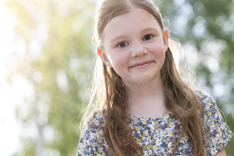 Closeup portrait of cute smiling girl with brown hair