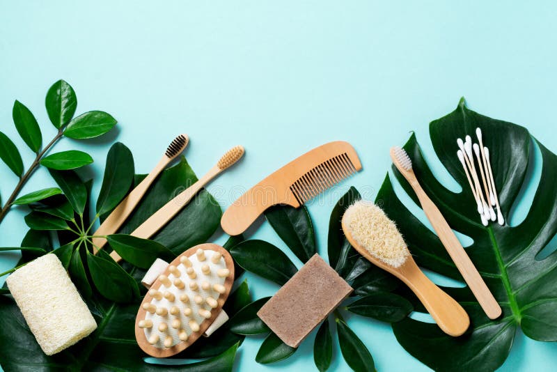 Eco friendly bathroom accessories or Spa tools on leaves monstera on blue background. Cosmetic concrete background.