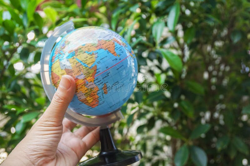 Eco-friendly concept - people hold globe map with nature background stock photography
