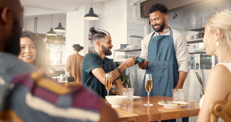 Ecommerce has made life so much easier. a young man making a card payment using a nfc machine. royalty free stock photos