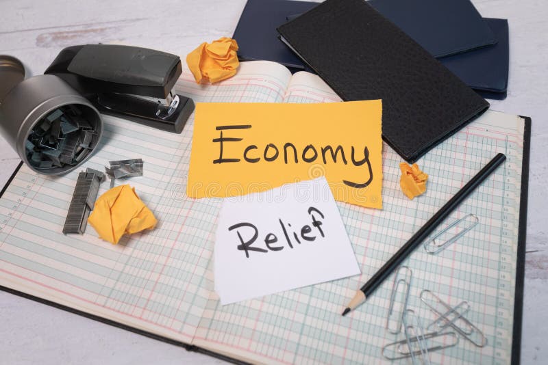 Economy relief sign laying on an open small business bookkeeping financial account ledger