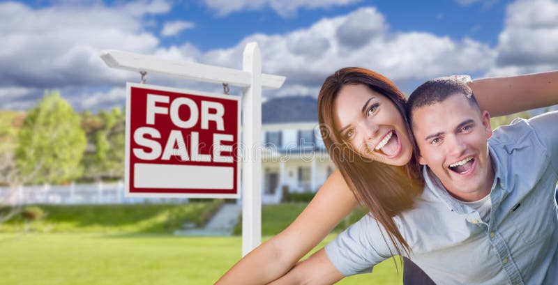 Ecstatic Young Military Couple In Front of Home with For Sale Sign stock image Ecstatic Young Military Couple In Front of Home with For Sale Sign stock image