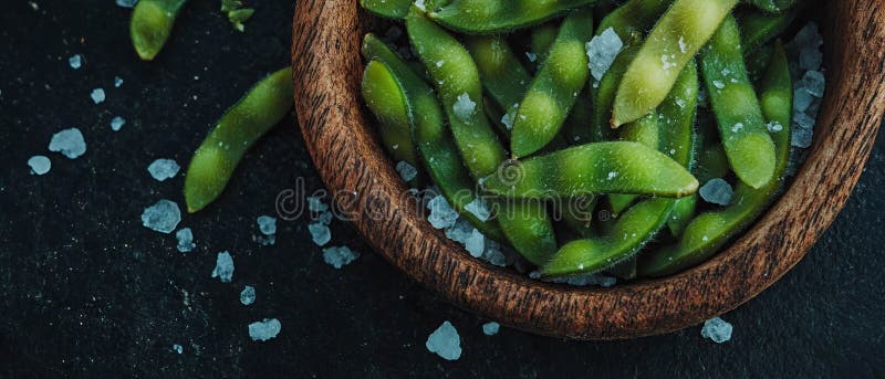 Edamame sprinklad med havssalt i en rustik skål för ett hälsosamt japanskt snack-alternativ arkivfoton