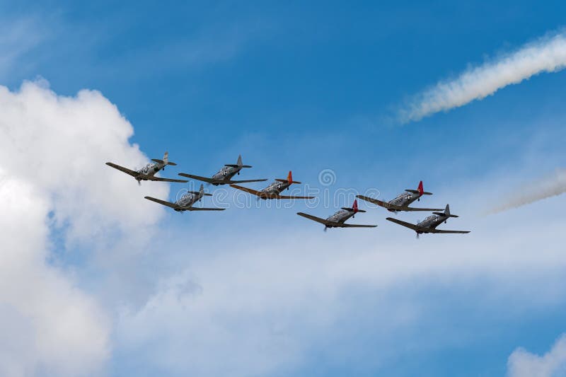 EDEN PRAIRIE, MN - JULY 16, 2016: AT6 Texan planes fly away at air show. The AT6 Texan was primarily used as trainer aircraft during and after World War II. EDEN PRAIRIE, MN - JULY 16, 2016: AT6 Texan planes fly away at air show. The AT6 Texan was primarily used as trainer aircraft during and after World War II.