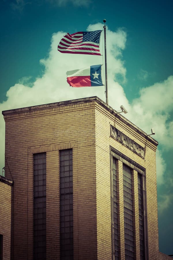 Part of Houston`s skyline and landscape, old architecture with USA and Texas flags flying overhead. Part of Houston`s skyline and landscape, old architecture with USA and Texas flags flying overhead.