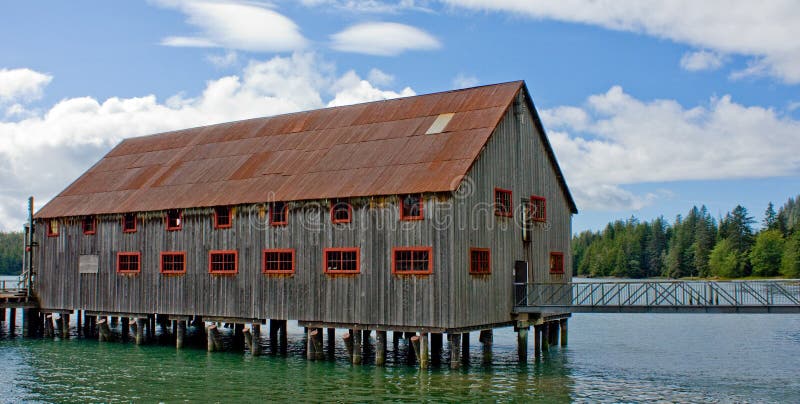 An old cannery net loft built on stilts at the edge of the ocean in Port Edward, British Columbia, Canada. An old cannery net loft built on stilts at the edge of the ocean in Port Edward, British Columbia, Canada.
