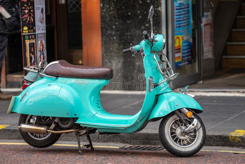 Edinburgh, Scotland, August 8th 2019. Bright aqua blue motor scooter parked on the street stock images Edinburgh, Scotland, August 8th 2019. Bright aqua blue motor scooter parked on the street stock images