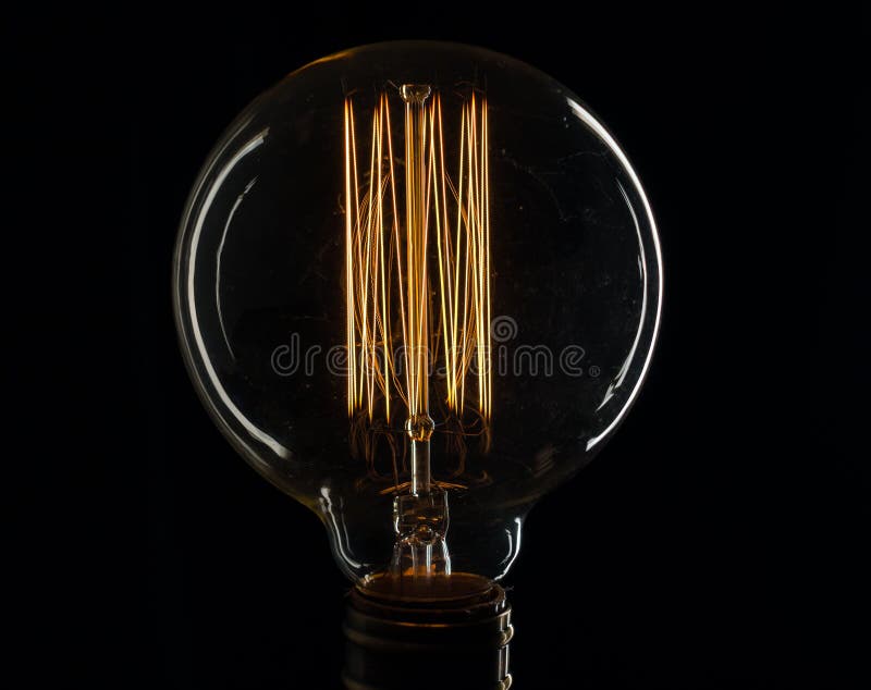 Edison`s Light Bulb Illuminates from Electric Current Stock Photo