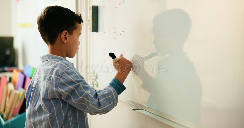 Education, child and math on whiteboard, classroom and problem solving with calculation and writing. Knowledge, counting royalty free stock image