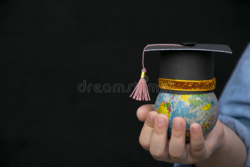 Education in Global world, Graduation cap on the girl`s hand holding Earth
