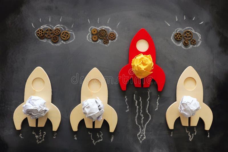 Education or innovation concept. Wooden rocket over blackboard background. top view stock photo
