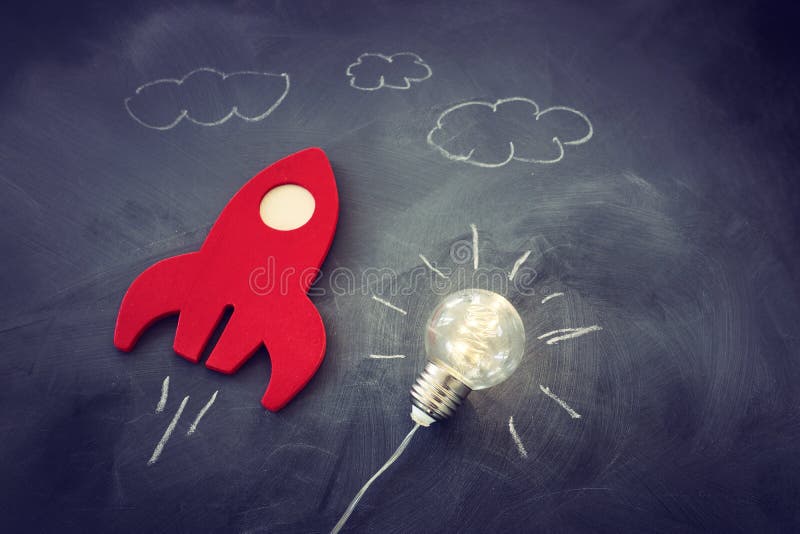 Education or innovation concept. Wooden rocket over blackboard background. top view royalty free stock photos