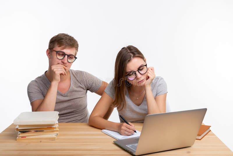 Education, people and relationship concept - a couple of students are tired of doing homework stock photos