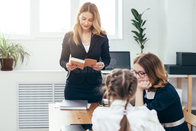 Education school lesson female teacher read book to her pupils royalty free stock photos Education school lesson female teacher read book to her pupils royalty free stock photos