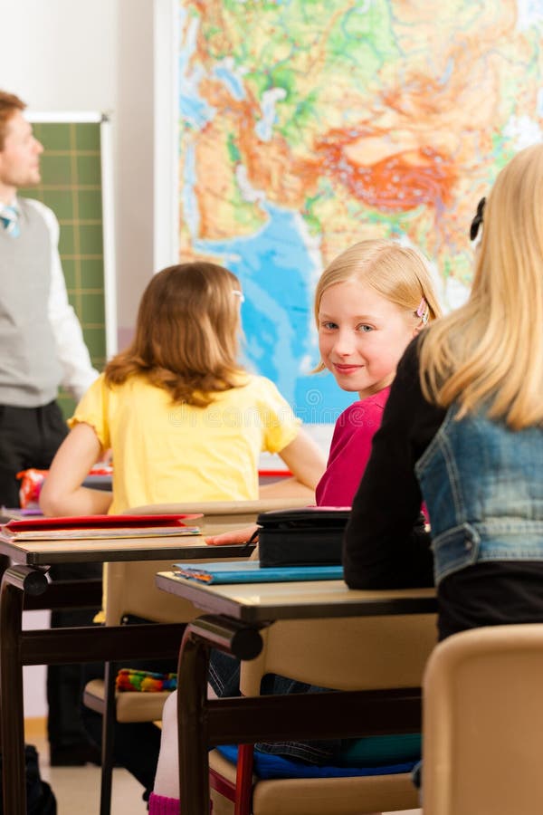 Education - Teacher with pupil in school teaching