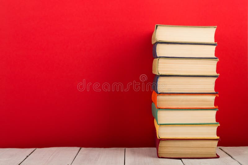 education and wisdom concept - open book on wooden table, color background