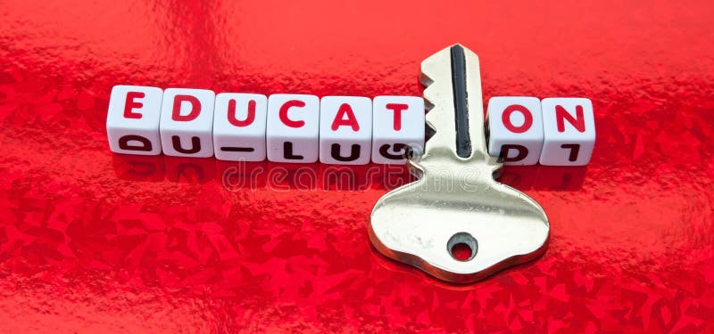 Text 'education' inscribed in red letters on small white cubes with letter 'i' replaced by a golden key. red background. Text 'education' inscribed in red letters on small white cubes with letter 'i' replaced by a golden key. red background.