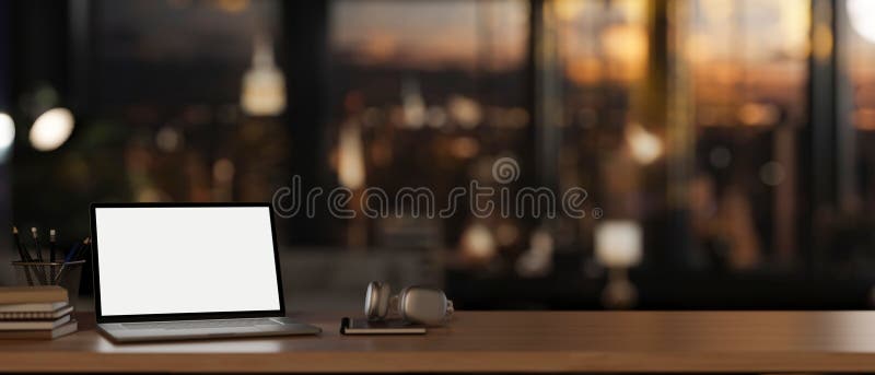 An office desk features a white-screen laptop computer mockup, headphones, and decor in a modern dark company office. 3d render, 3d illustration. An office desk features a white-screen laptop computer mockup, headphones, and decor in a modern dark company office. 3d render, 3d illustration