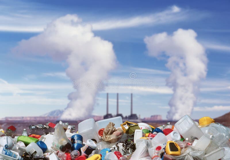 A conceptual image that describes pollution, a pile of waste against the background of chimneys emitting polluting smoke. A conceptual image that describes pollution, a pile of waste against the background of chimneys emitting polluting smoke