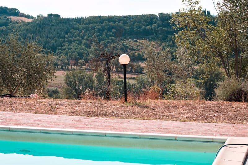 An isolated lamp in the garden near the swimming pool Umbria, Italy, Europe. An isolated lamp in the garden near the swimming pool Umbria, Italy, Europe